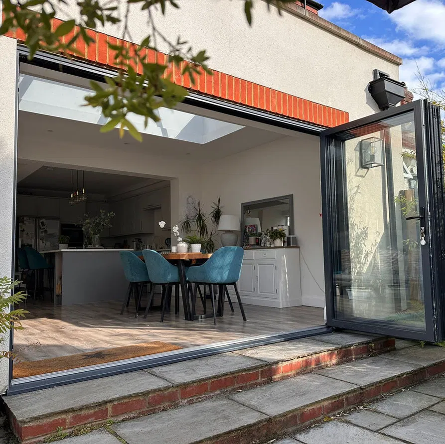 Modern open-plan kitchen and dining area with large skylights, ideal for high-standard HMO communal spaces